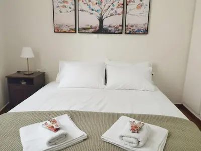 a bedroom with a bed with towels on it at Calliope's Neoclassical Home in the heart of Plaka in Athens