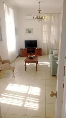 a living room with a couch and a table at Calliope's Neoclassical Home in the heart of Plaka in Athens
