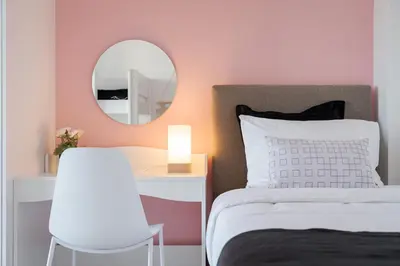 a bedroom with a white bed and a mirror at Glyfada Cozy Living in Athens