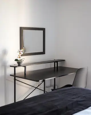 a desk in a bedroom with a mirror and a chair at Glyfada Cozy Living in Athens