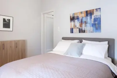 a bedroom with a large bed with white pillows at Urban Oasis Terrace 2Bebroom apartment in Athens