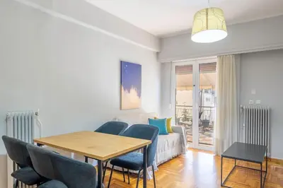 a living room with a table and chairs and a couch at Urban Oasis Terrace 2Bebroom apartment in Athens