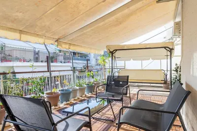 a group of chairs on a balcony with plants at Urban Oasis Terrace 2Bebroom apartment in Athens