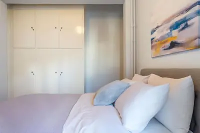 a bedroom with a white bed with white pillows at Urban Oasis Terrace 2Bebroom apartment in Athens