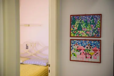 a bedroom with a bed and two pictures on the wall at Batis Sea View in Athens