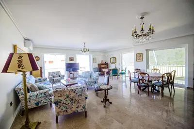 a living room filled with furniture and a table and chairs at Batis Sea View in Athens
