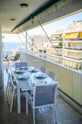 a white table and chairs on a balcony at Batis Sea View in Athens