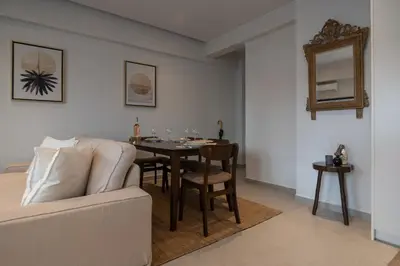 a living room with a table and a couch at Pagkrati Urban Living in Athens