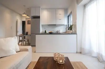 a living room with a couch and a table at Pagkrati Urban Living in Athens