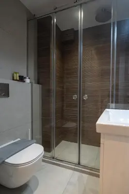 a bathroom with a shower and a toilet and a sink at Pagkrati Urban Living in Athens