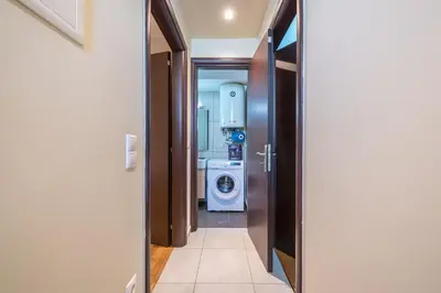 a hallway of a bathroom with a washer and dryer at Artistic 2BR Maisonette: An Architectural Delight in Athens