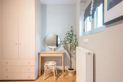 a dressing room with a mirror and a stool at Artistic 2BR Maisonette: An Architectural Delight in Athens