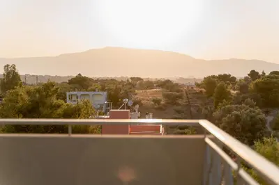 a balcony with a view of the mountains at Starfish Complex in Porto Rafti