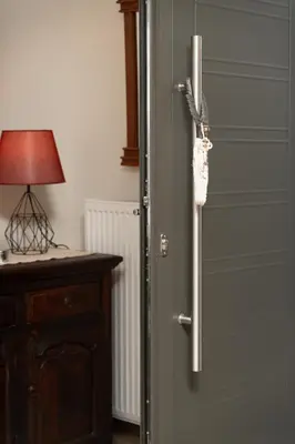 a door with a handle next to a table with a lamp at Starfish Complex in Porto Rafti