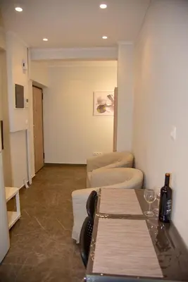 a room with a table and some chairs and a room at Lovely Apartment in Athens