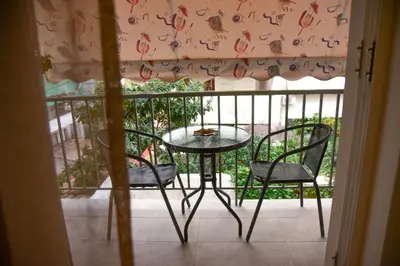 a table and two chairs on a balcony with a table at Lovely Apartment in Athens