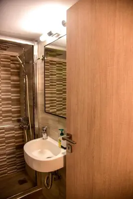 a bathroom with a sink and a mirror at Lovely Apartment in Athens