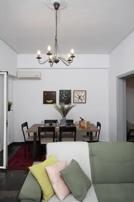 a living room with a couch and a table at Lovely,central, spacious 2-bedrooms apartment in Piraeus