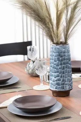 a wooden table with plates and glasses and a vase at Lovely,central, spacious 2-bedrooms apartment in Piraeus