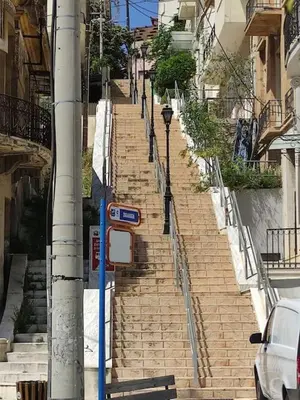 a set of stairs leading up to a building at Lovely,central, spacious 2-bedrooms apartment in Piraeus