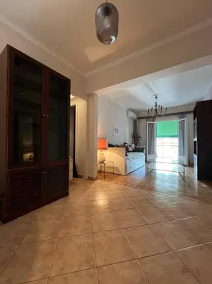 a large living room with a large tiled floor at 4th floor cosy apartment in Metaxourgeio in Athens