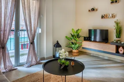 a living room with a table and a tv at City Break Apartment 4' to Metro in Athens