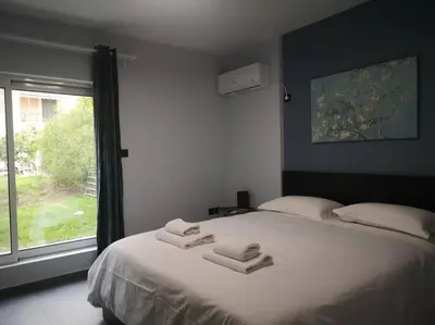 a bedroom with a large bed with towels on it at Ground floor apt. with garden, Timfristou 86 Chalandri in Athens