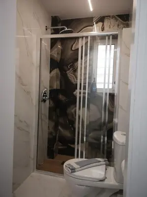 a bathroom with a shower with a toilet in it at Ground floor apt. with garden, Timfristou 86 Chalandri in Athens