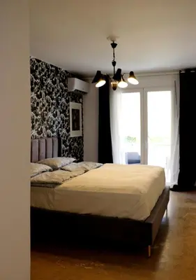 a bedroom with a large bed and a window at Luxurious studio apartment close to the beach and airport in Porto Rafti