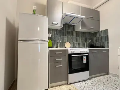 a kitchen with a refrigerator and a stove at Artist's 1 BD Apt in Keramikos in Athens