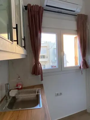 a kitchen with a sink and a window at Azure Studio in Athens