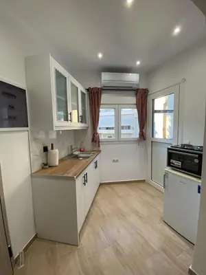 a kitchen with white cabinets and a counter top at Azure Studio in Athens