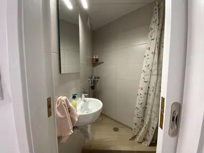 a small bathroom with a sink and a mirror at Azure Studio in Athens