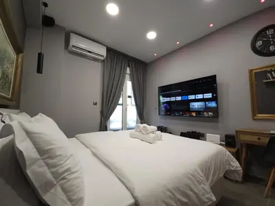 a bedroom with a white bed with a stuffed animal on it at DIONE Luxury Business Suite in the heart of Athens in Athens