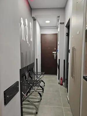 a hallway with a chair in front of a door at DIONE Luxury Business Suite in the heart of Athens in Athens