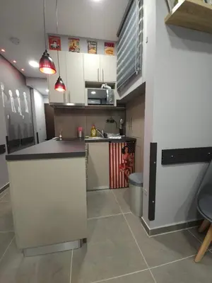 a kitchen with white cabinets and a counter top at DIONE Luxury Business Suite in the heart of Athens in Athens
