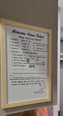 a sign for a welcome home permit in a wooden frame at DIONE Luxury Business Suite in the heart of Athens in Athens
