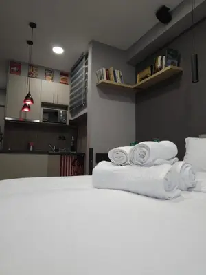a pile of towels sitting on top of a bed at DIONE Luxury Business Suite in the heart of Athens in Athens