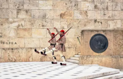 a painting of two people jumping in front of a wall at DIONE Luxury Business Suite in the heart of Athens in Athens