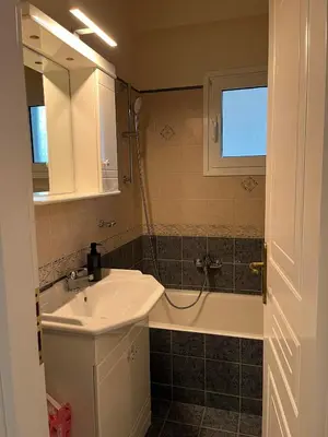 a bathroom with a sink and a bath tub at Spata Airside Apartment in Spáta