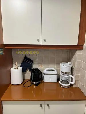 a kitchen counter with various appliances on it at Spata Airside Apartment in Spáta