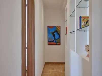 a hallway with a door and a painting on the wall at Parthenon Panorama 3bd in Athens