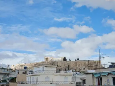 a view of the acropolis of athens from behind buildings at Parthenon Panorama 3bd in Athens
