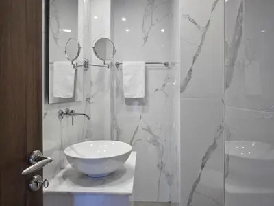 a bathroom with a sink and a glass shower at Parthenon Panorama 3bd in Athens