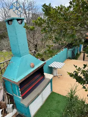 a blue stove sitting on top of a yard at DianaBNB in Artemida