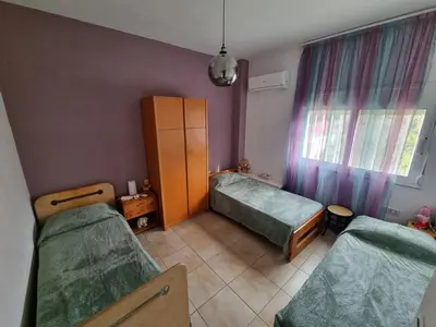 a small room with two beds and a window at DianaBNB in Artemida