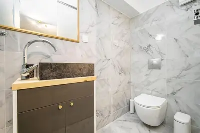 a white bathroom with a toilet and a sink at modern boutique apartment in Athens