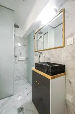a bathroom with a sink and a mirror at modern boutique apartment in Athens