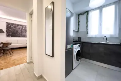 a kitchen with a sink and a washing machine at Spacious Penthouse near Downtown in Athens