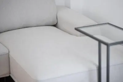 a white couch sitting next to a side table at Spacious Penthouse near Downtown in Athens
